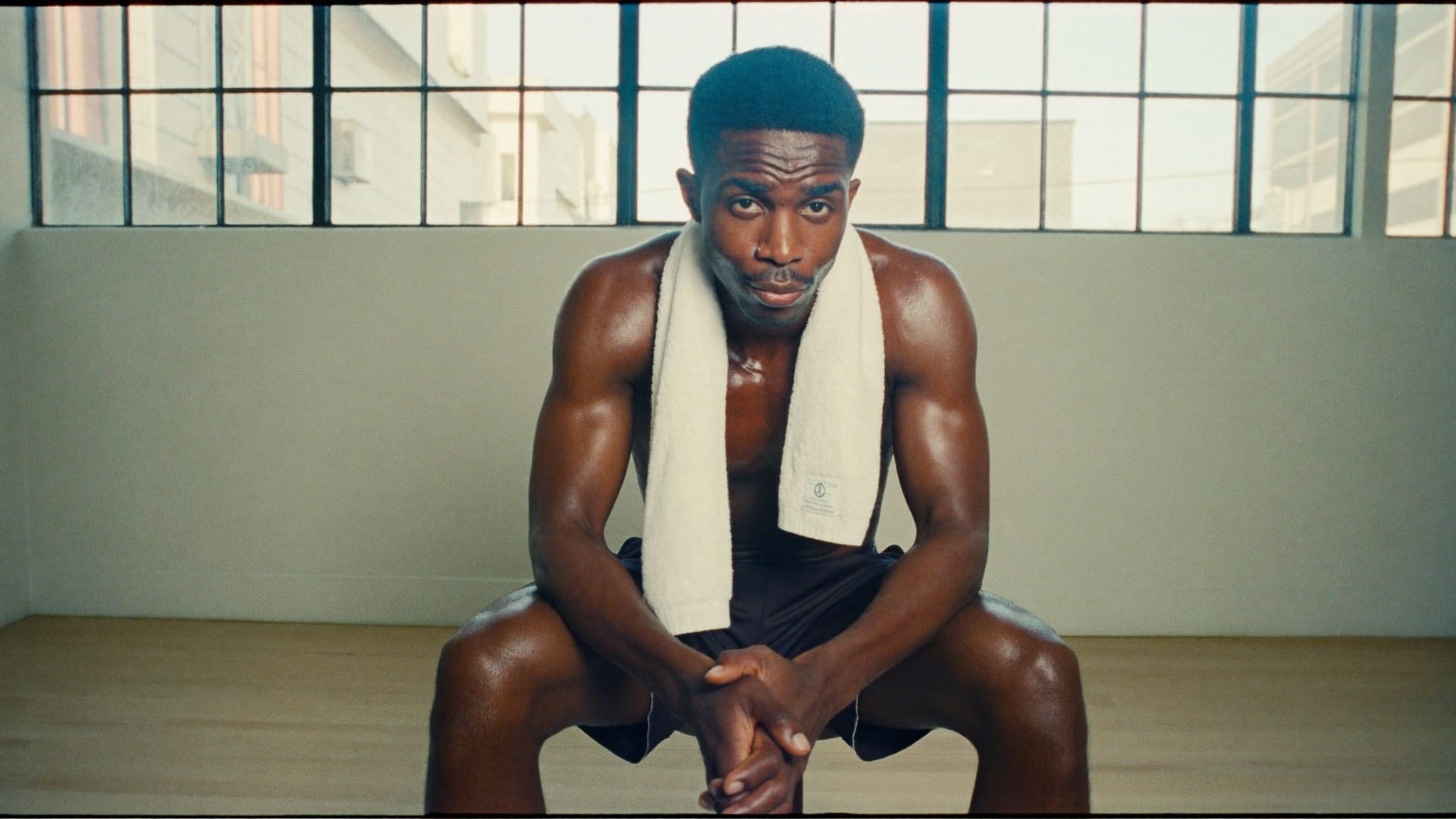 Athlete resting after training in a bright minimal gym