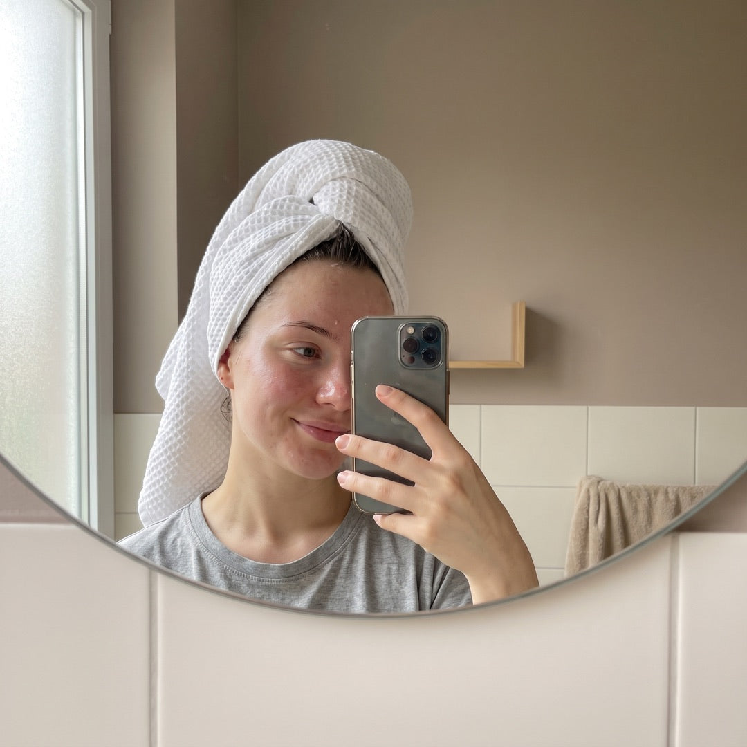 Mirror selfie after cleansing, hair wrapped in a towel
